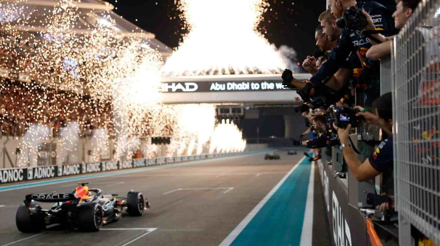 Fireworks light the sky as the F1 car crosses the line.