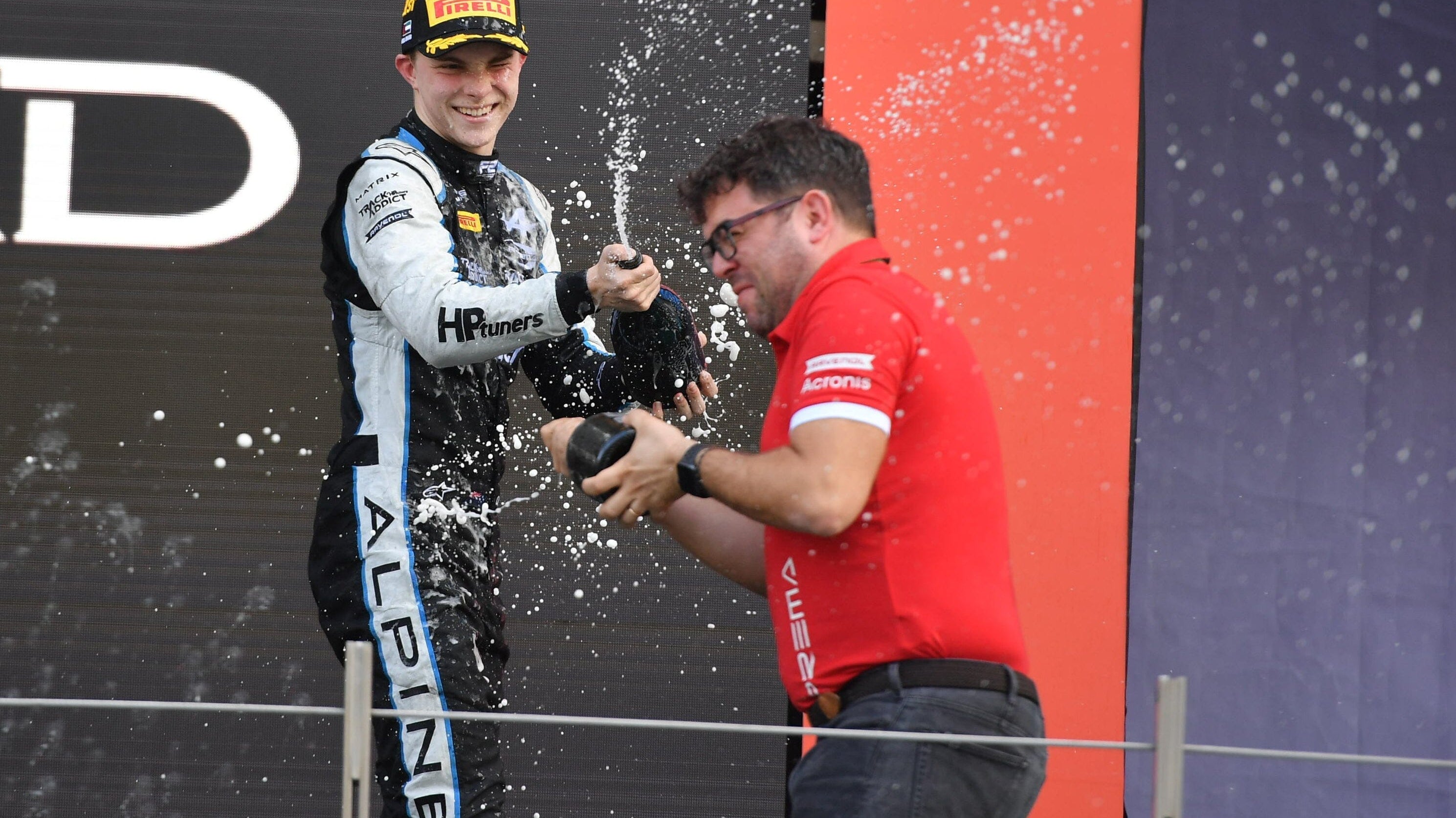 Prema Racing driver Oscar Piastri on Abu Dhabi podium spraying champagne