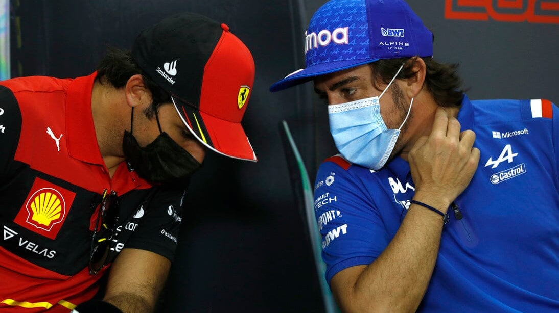 two F1 2022 drivers with masks talking