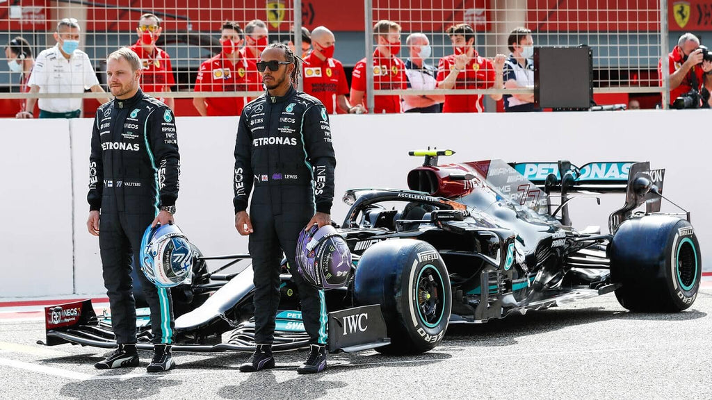 Bottas and Hamilton standing in front of the Mercedes F1 car