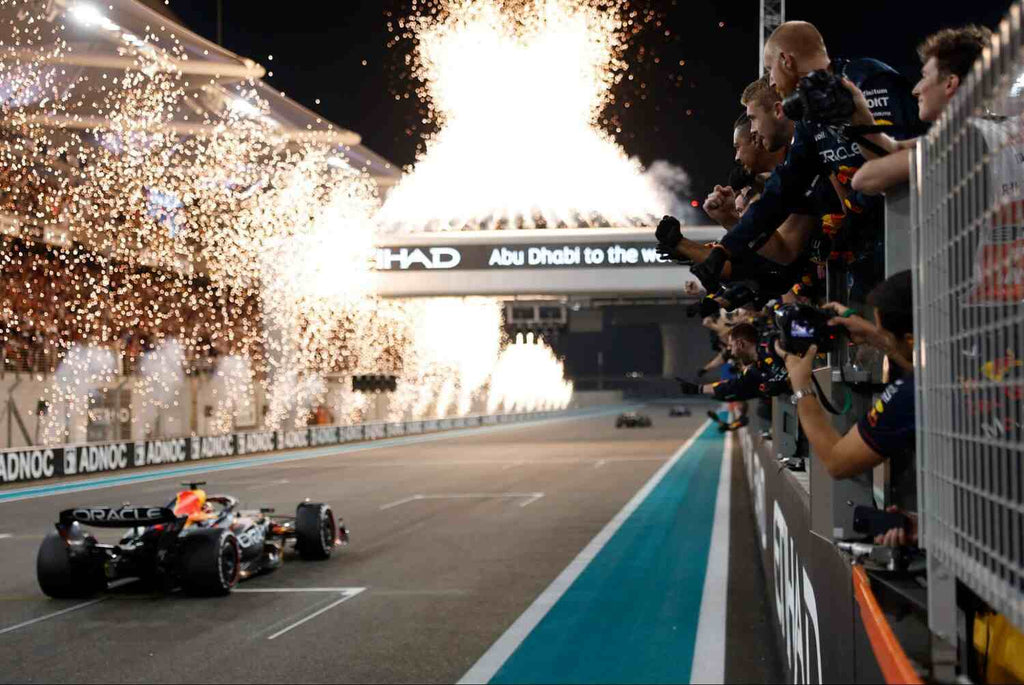 Fireworks light the sky as the F1 car crosses the line.