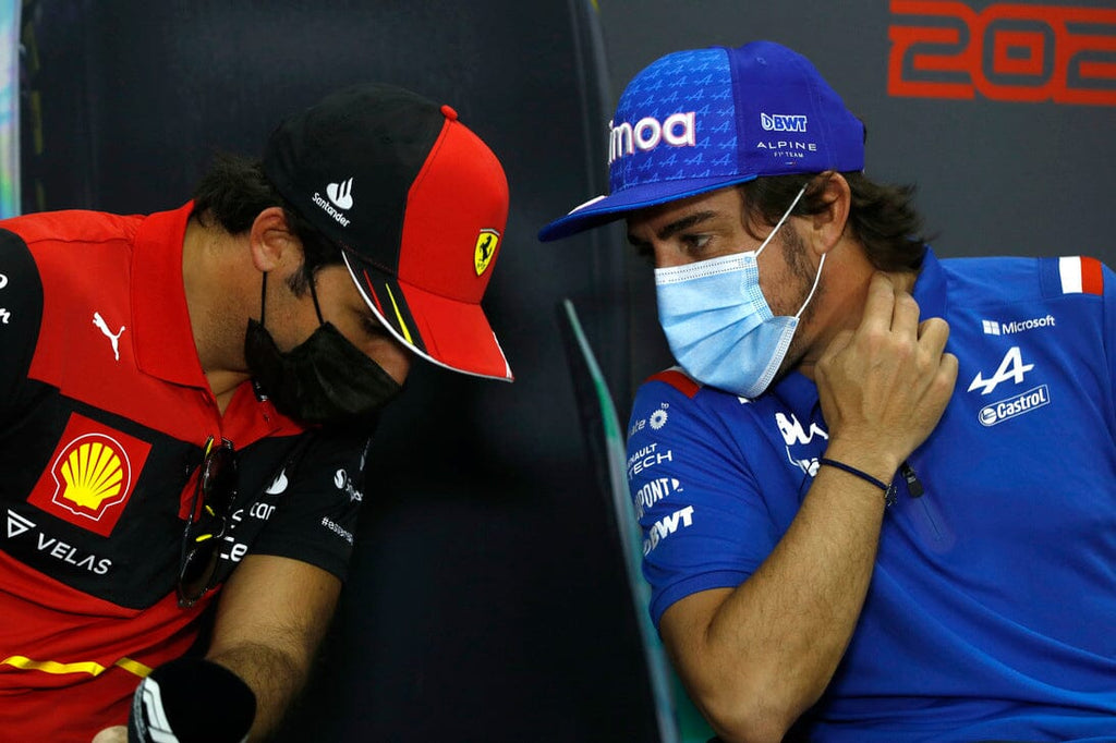 two F1 2022 drivers with masks talking