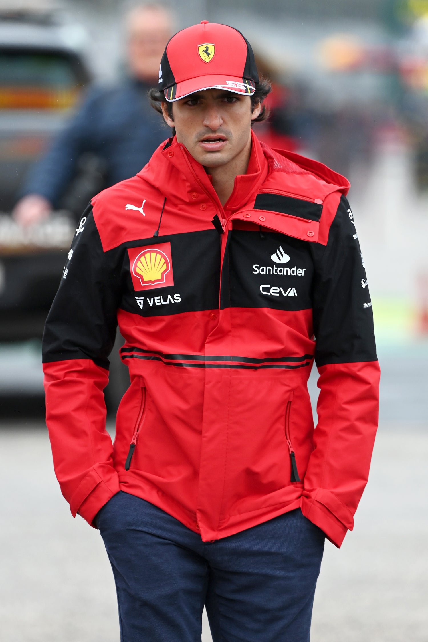 man wearing red F1 team jacket and hat